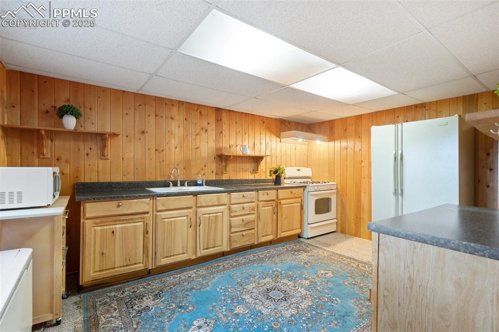 351 Porphry Road Florissant, CO 80816 - Photo 20 of 39 a kitchen with granite countertop a sink and white cabinets