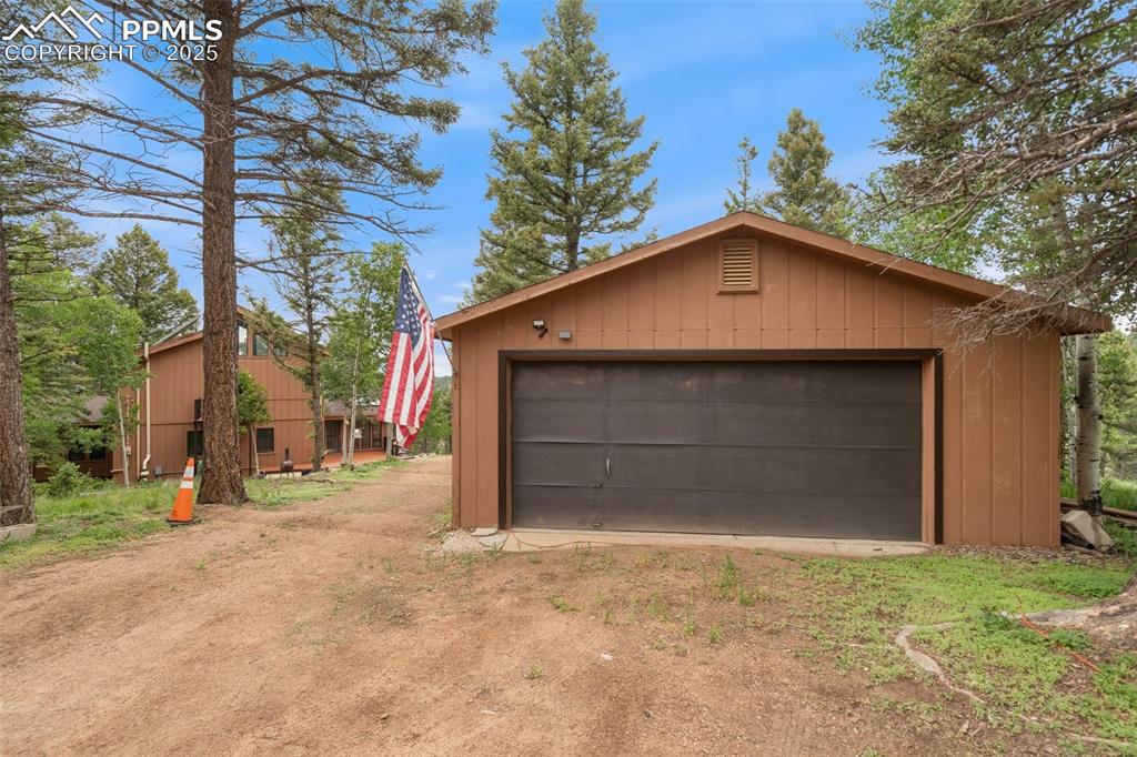 351 Porphry Road Florissant, CO 80816 - Photo 31 of 39 a front view of a house with a yard and garage