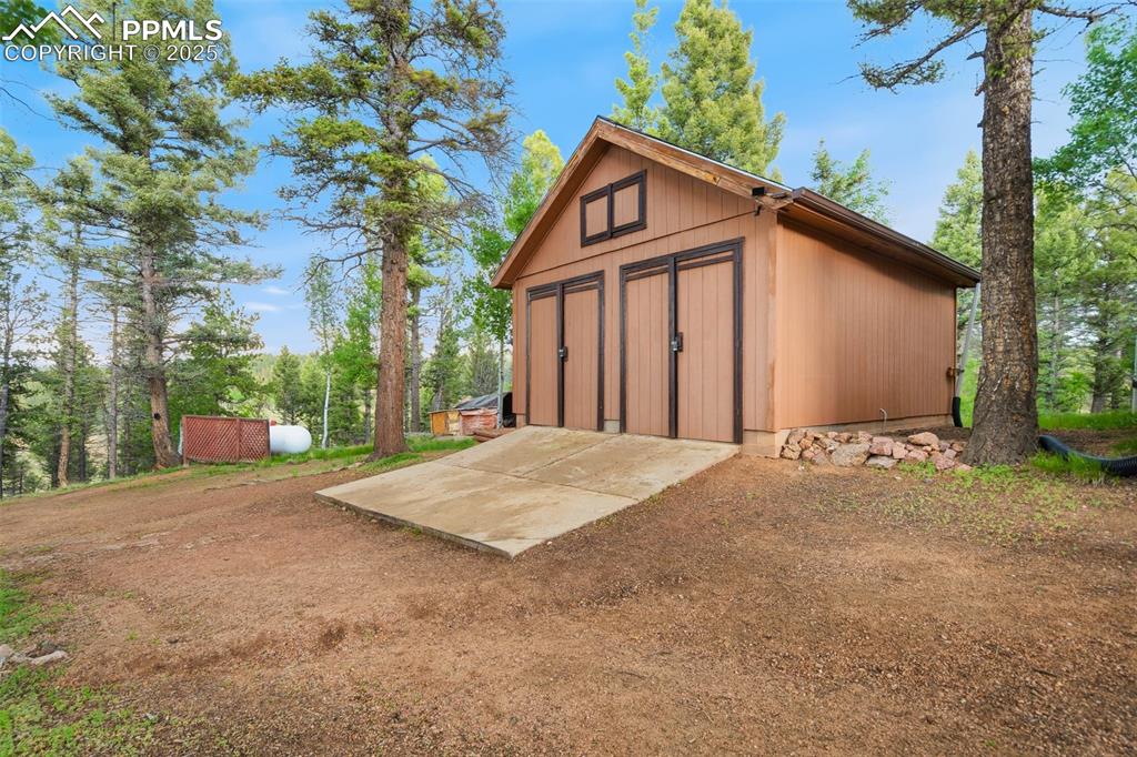 351 Porphry Road Florissant, CO 80816 - Photo 33 of 39 a front view of a house with a yard and garage