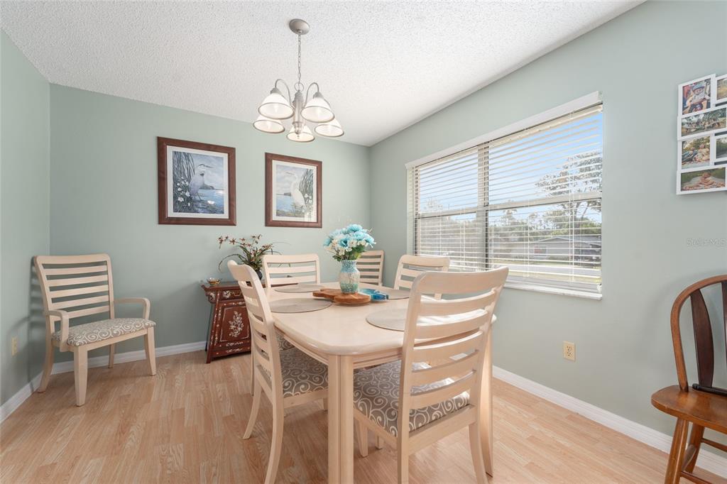21373 Southwest Raintree Street Dunnellon, FL 34431 - Photo 11 of 39 a view of a dining room with furniture window and wooden floor
