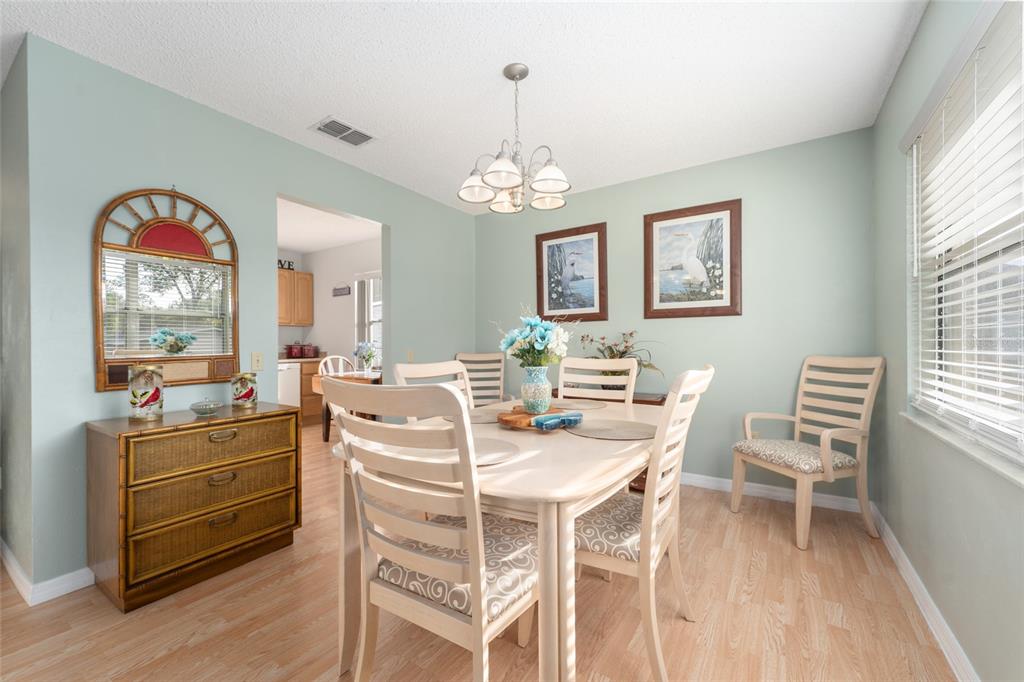 21373 Southwest Raintree Street Dunnellon, FL 34431 - Photo 12 of 39 a view of a dining room with furniture window and wooden floor