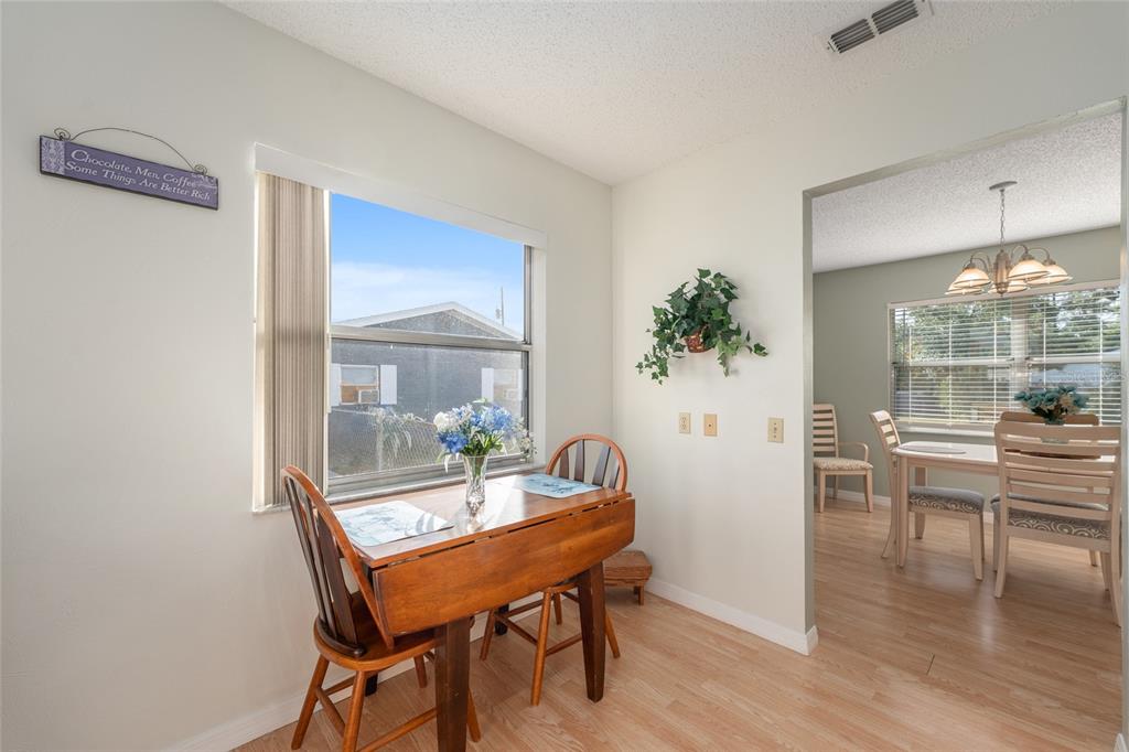 21373 Southwest Raintree Street Dunnellon, FL 34431 - Photo 19 of 39 a view of a dining room with furniture and wooden floor