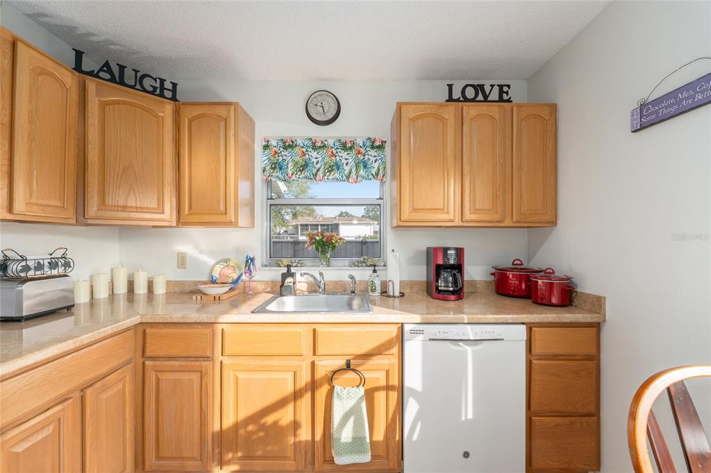 21373 Southwest Raintree Street Dunnellon, FL 34431 - Photo 20 of 39 a kitchen with stainless steel appliances granite countertop a sink stove and cabinets