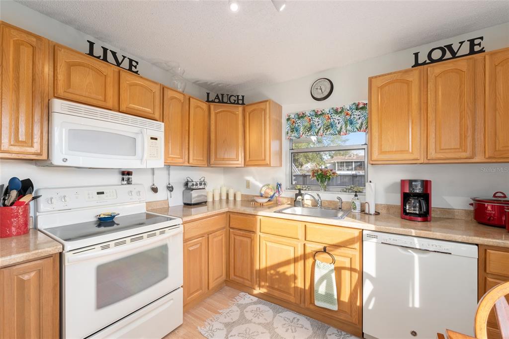 21373 Southwest Raintree Street Dunnellon, FL 34431 - Photo 21 of 39 a kitchen with a sink cabinets and window