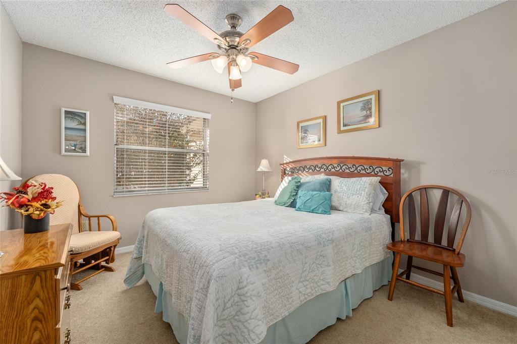 21373 Southwest Raintree Street Dunnellon, FL 34431 - Photo 23 of 39 a bedroom with a bed and a chandelier