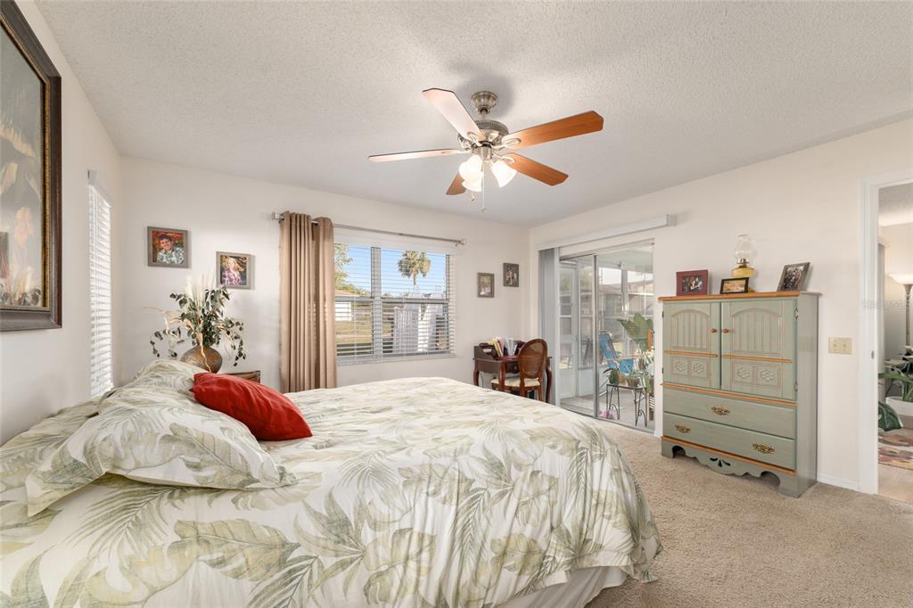 21373 Southwest Raintree Street Dunnellon, FL 34431 - Photo 28 of 39 a bedroom with a large bed and a chandelier