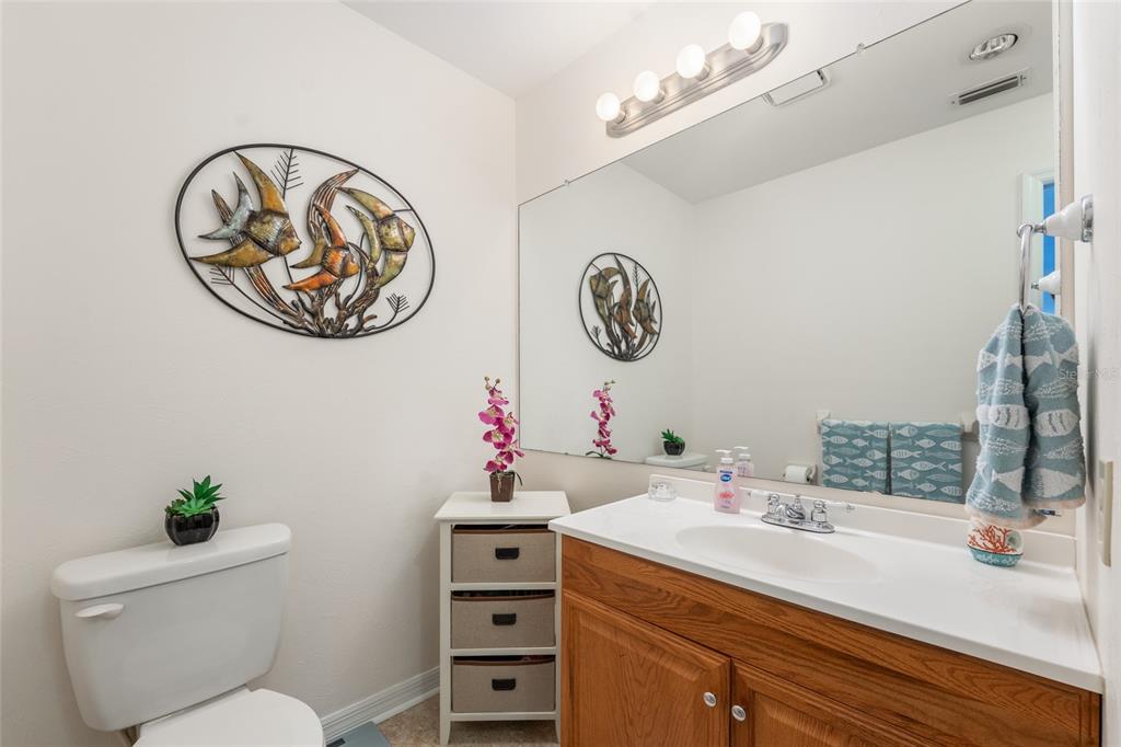21373 Southwest Raintree Street Dunnellon, FL 34431 - Photo 29 of 39 a bathroom with a sink a mirror and a toilet