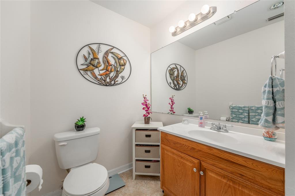 21373 Southwest Raintree Street Dunnellon, FL 34431 - Photo 31 of 39 a bathroom with a toilet sink vanity and mirror