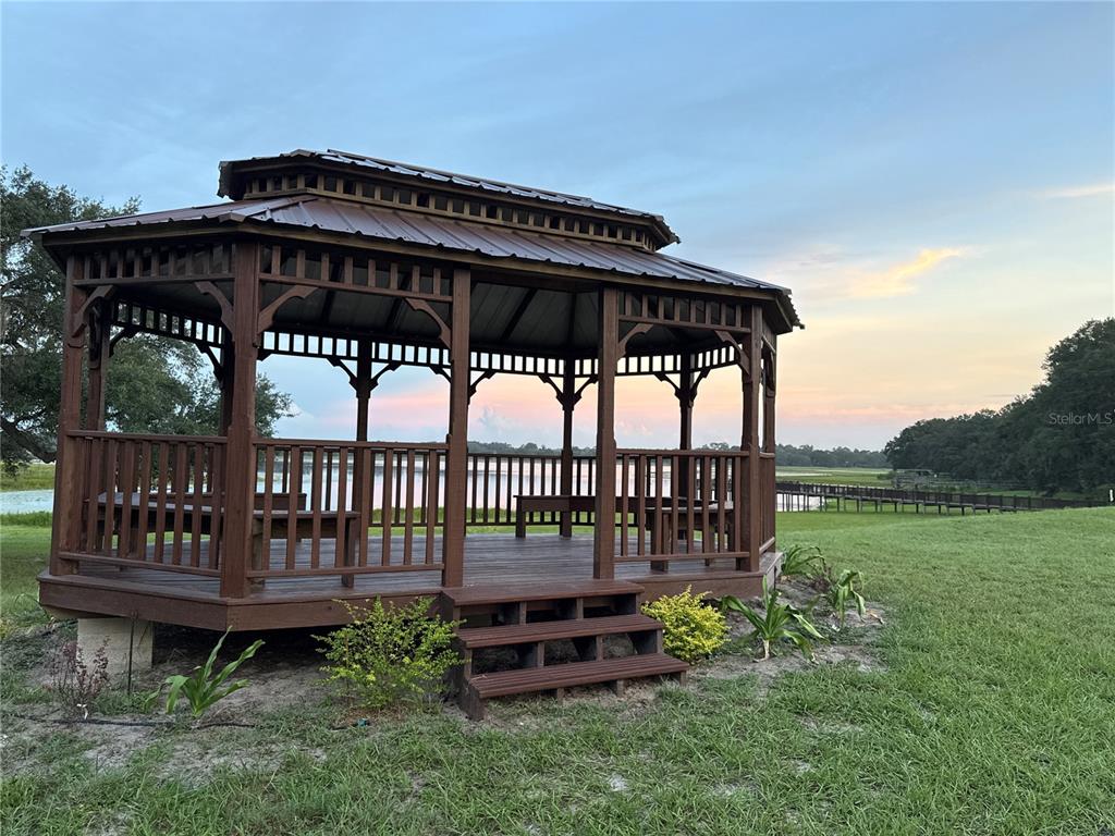 21373 Southwest Raintree Street Dunnellon, FL 34431 - Photo 34 of 39 a view of a chair and table in the yard
