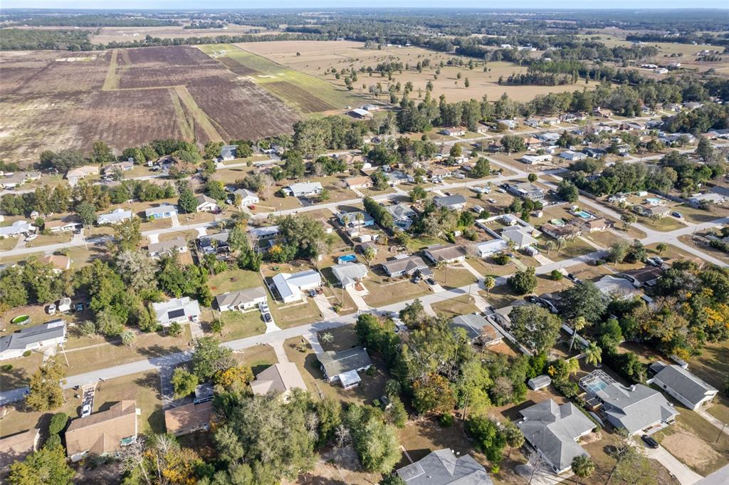 21373 Southwest Raintree Street Dunnellon, FL 34431 - Photo 4 of 39 an aerial view of a city with lots of residential buildings
