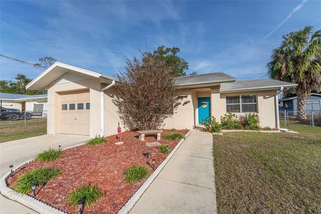 21373 Southwest Raintree Street Dunnellon, FL 34431 - Photo 6 of 39 a front view of a house with garden