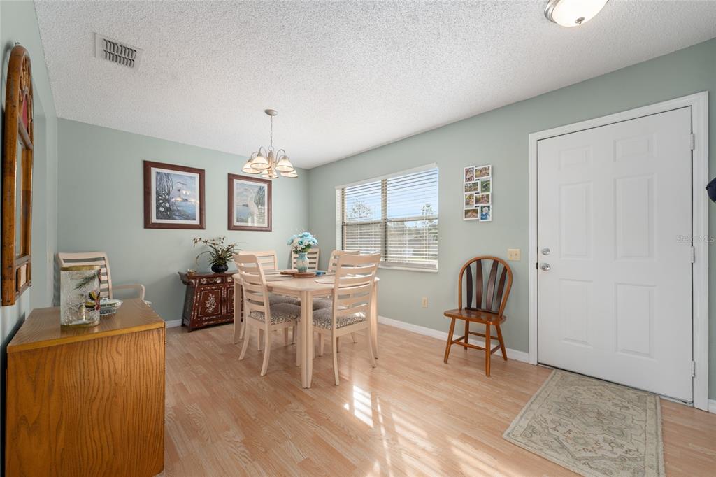 21373 Southwest Raintree Street Dunnellon, FL 34431 - Photo 9 of 39 a view of a dining room with furniture window and wooden floor