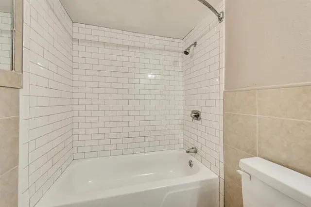 a bathroom with a bathtub and a toilet