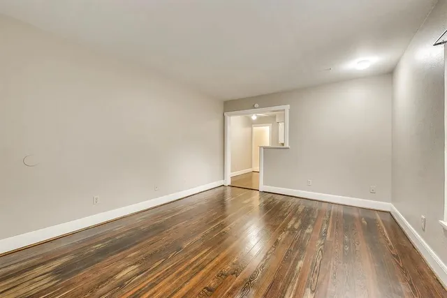 a view of an empty room and wooden floor