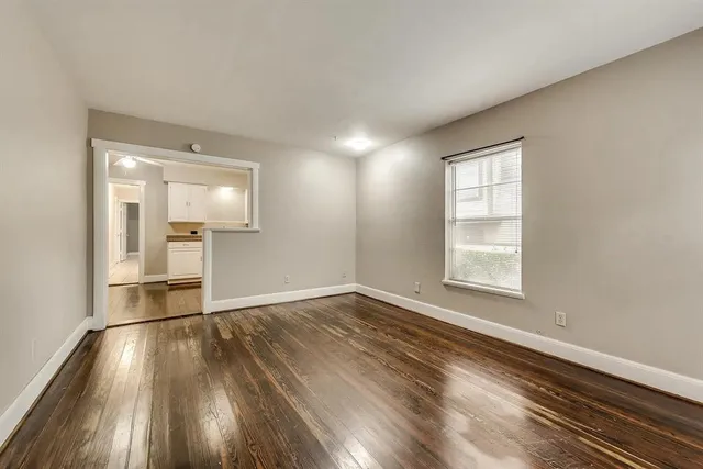 wooden floor in an empty room with a window