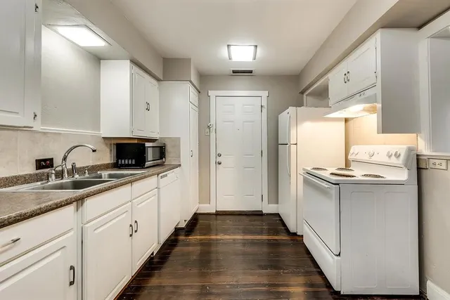 a kitchen with a sink stove and refrigerator