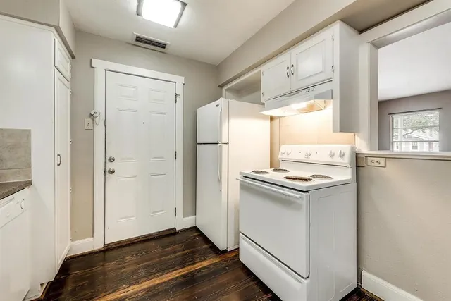 a kitchen with stainless steel appliances a stove a refrigerator and a cabinets