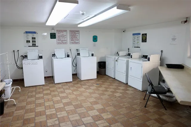 a room with furniture a white stove a table and white walls