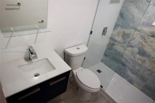 a white toilet sitting next to a bathroom sink