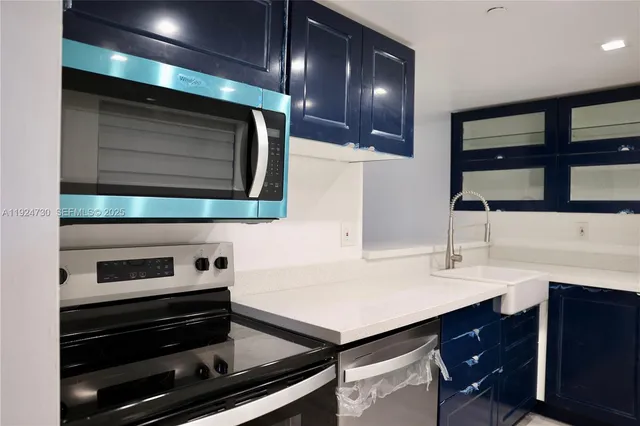 a kitchen with stainless steel appliances cabinets and oven