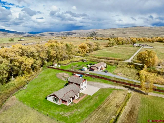 an aerial view of a house with a ocean view