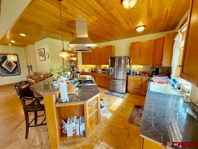 a living room with furniture a dining table and wooden floor