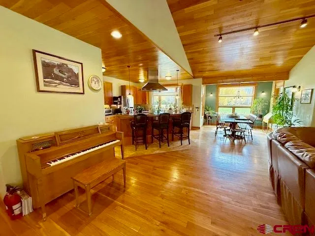 a view of a dining room with furniture and a potted plant