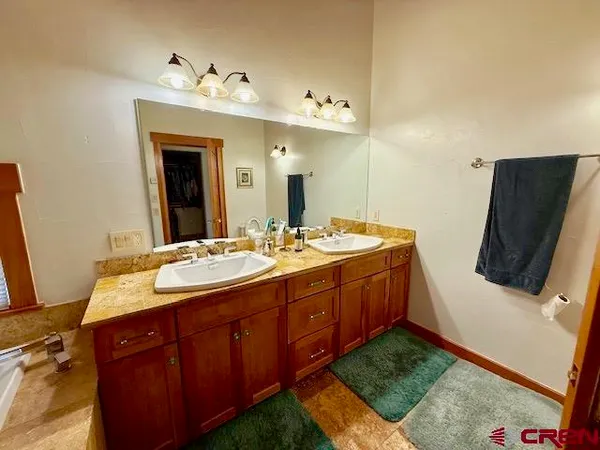 a living room with furniture a window and a flat screen tv