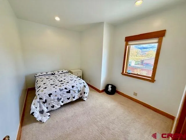 a bedroom with a bed and a chair