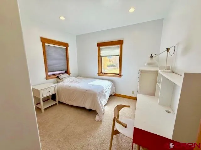 a bedroom with a bed and a mirror