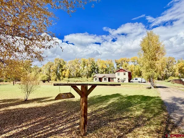 a view of yard with large trees