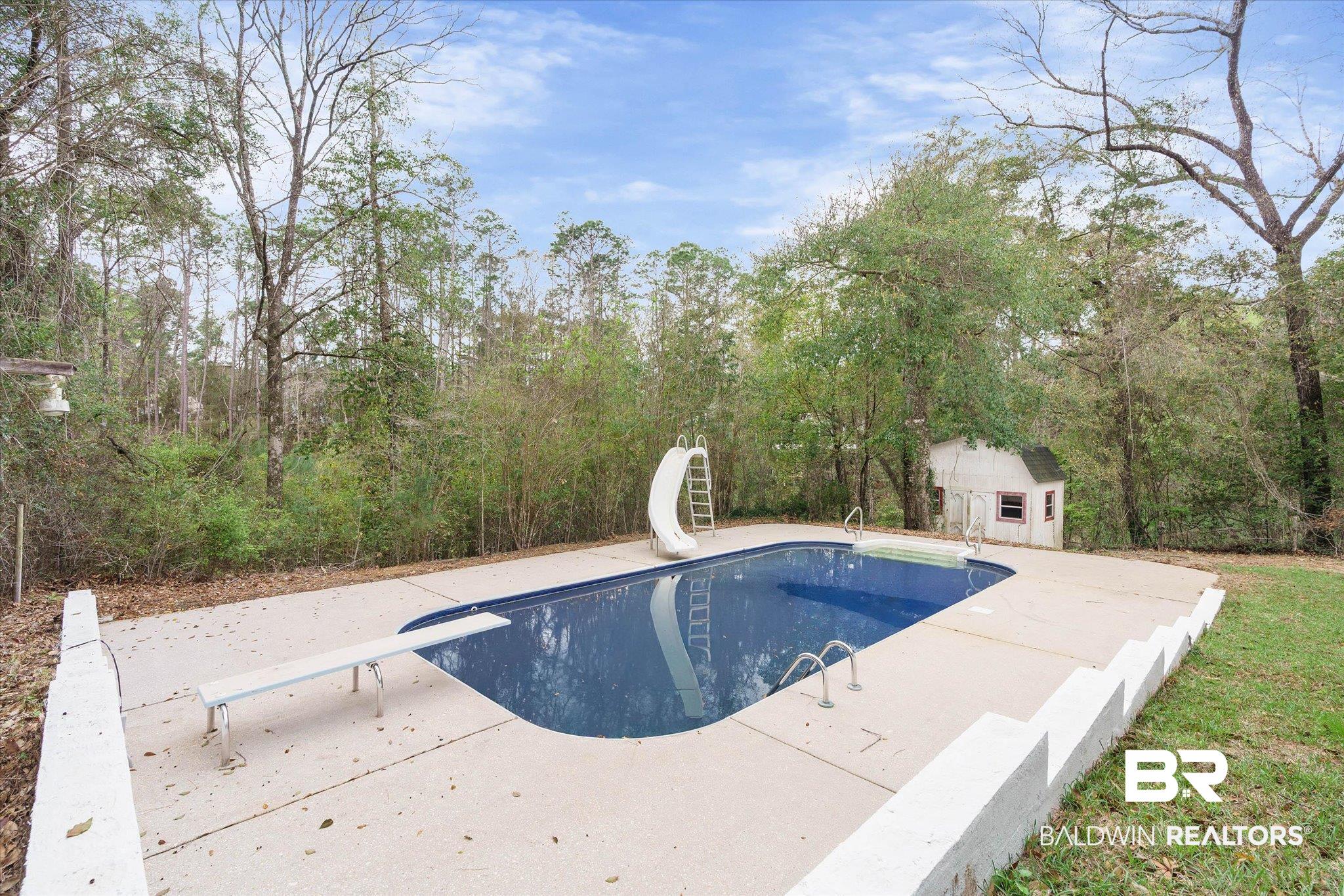 106 Melanie Loop Daphne, AL 36526 - Photo 35 of 45 Outdoor pool with a diving board, a patio area, a water slide, and an outdoor structure