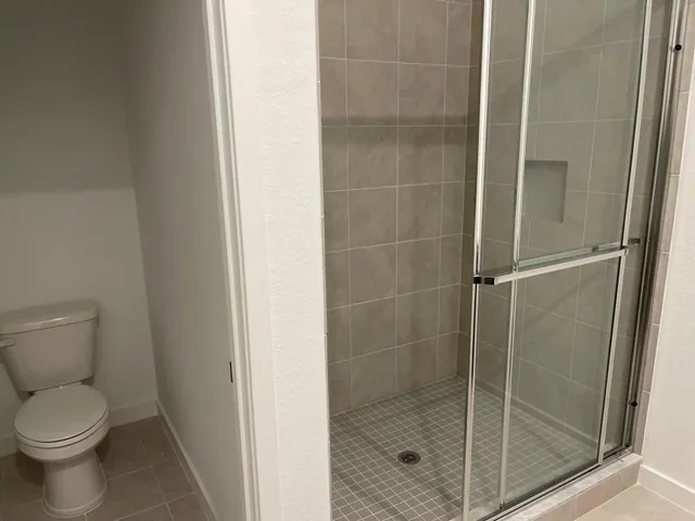 a bathroom with a toilet and shower