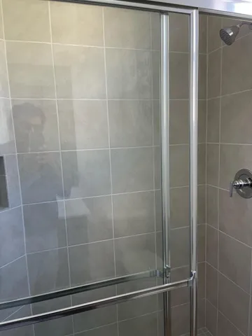 a bathroom with a glass shower door