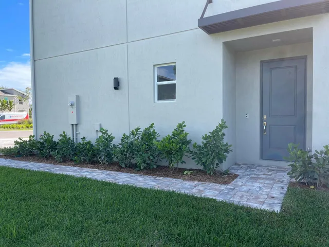 a view of a backyard with potted plants