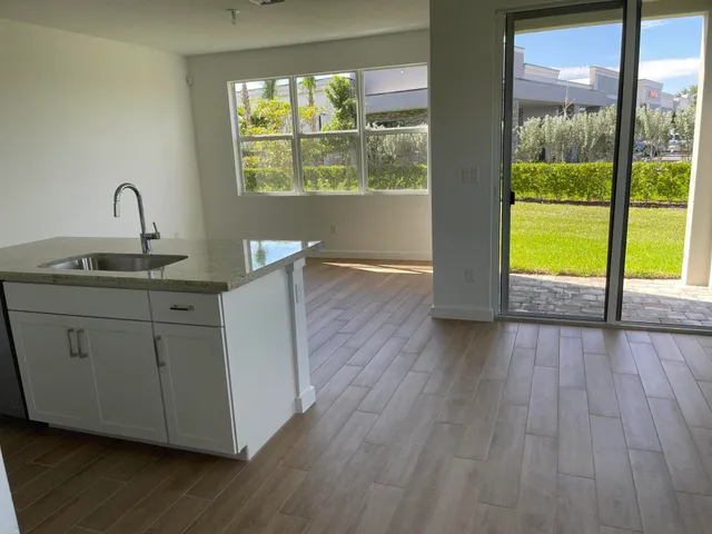 a kitchen with a sink and wooden floor