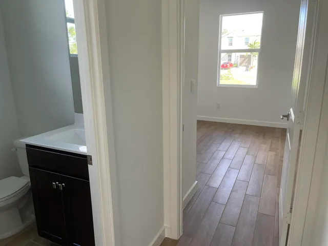 a view of an empty room and wooden floor