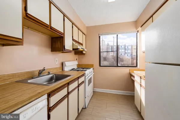 a kitchen with a sink and a refrigerator