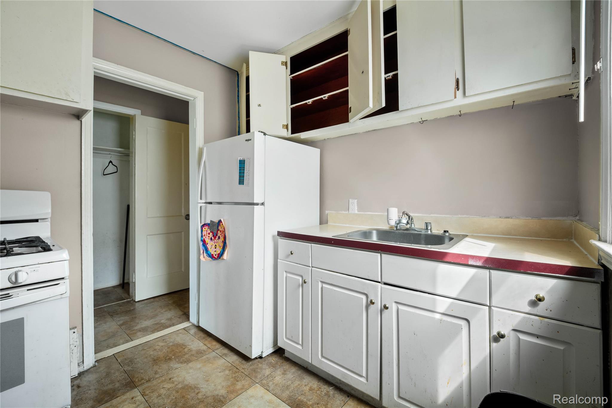 4049 Williams Street Inkster, MI 48141 - Photo 16 of 21 Kitchen with white appliances, white cabinets, open shelves, and light countertops