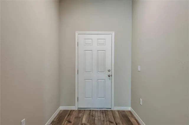 a view of front door with wooden floor