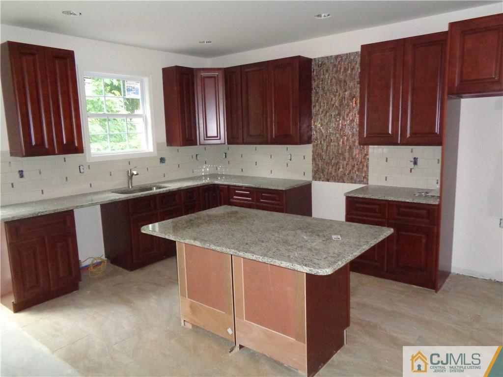 15 Altamont Road Edison, NJ 08817 - Photo 5 of 7 a kitchen with a sink stove and cabinets