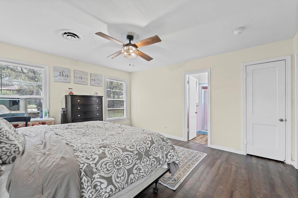 1208 Sunset Street Waco, TX 76710 - Photo 12 of 24 a large bedroom with a bed and a flat screen tv