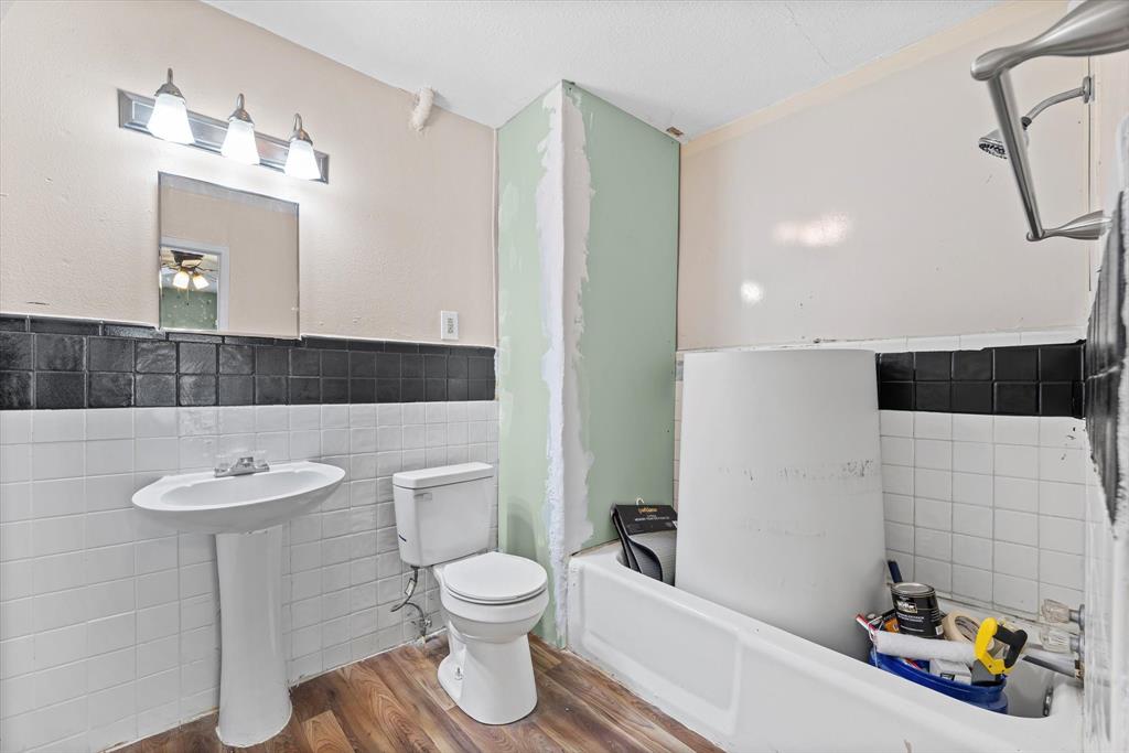 1208 Sunset Street Waco, TX 76710 - Photo 16 of 24 a bathroom with a toilet sink and mirror