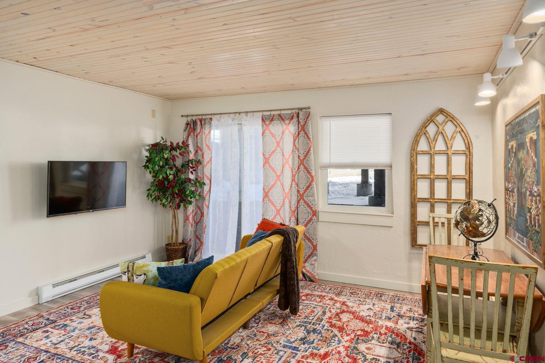 35 Emmons Road, Unit A Crested Butte, CO 81225 - Photo 8 of 28 a living room with furniture and a flat screen tv