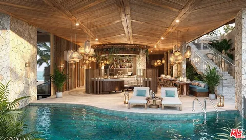 a view of a patio with table and chairs potted plants with floor to ceiling window