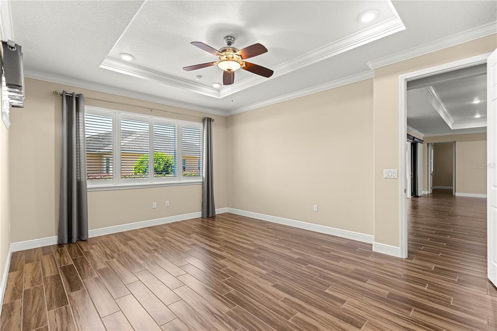 9460 Southwest 86th Place Ocala, FL 34481 - Photo 35 of 86 a view of an empty room with wooden floor and a window