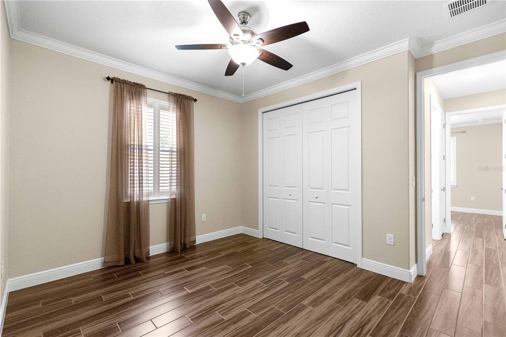 9460 Southwest 86th Place Ocala, FL 34481 - Photo 48 of 86 an empty room with wooden floor and windows