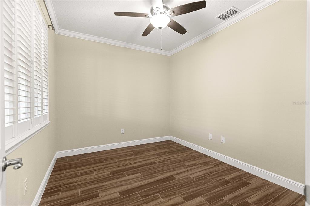 9460 Southwest 86th Place Ocala, FL 34481 - Photo 53 of 86 a view of a room with wooden floor and fan