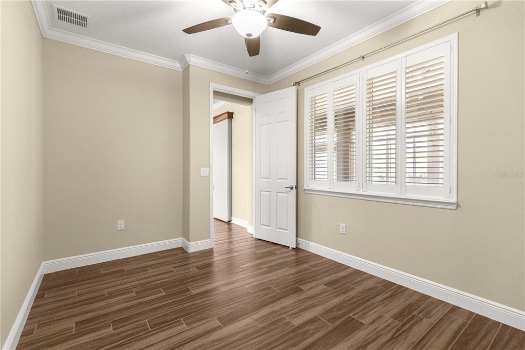 9460 Southwest 86th Place Ocala, FL 34481 - Photo 55 of 86 a view of an empty room with wooden floor and a window