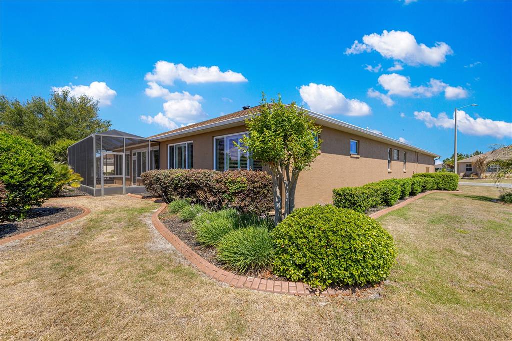 9460 Southwest 86th Place Ocala, FL 34481 - Photo 67 of 86 a view of a house with a yard and potted plants